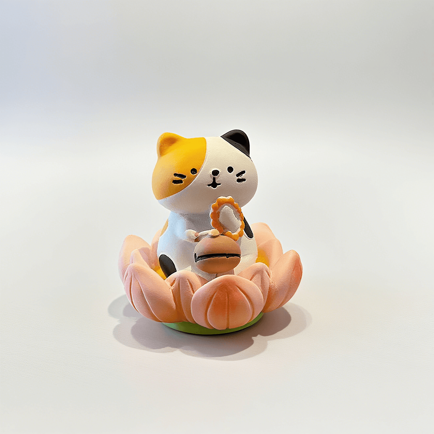a very cute calico cat figure